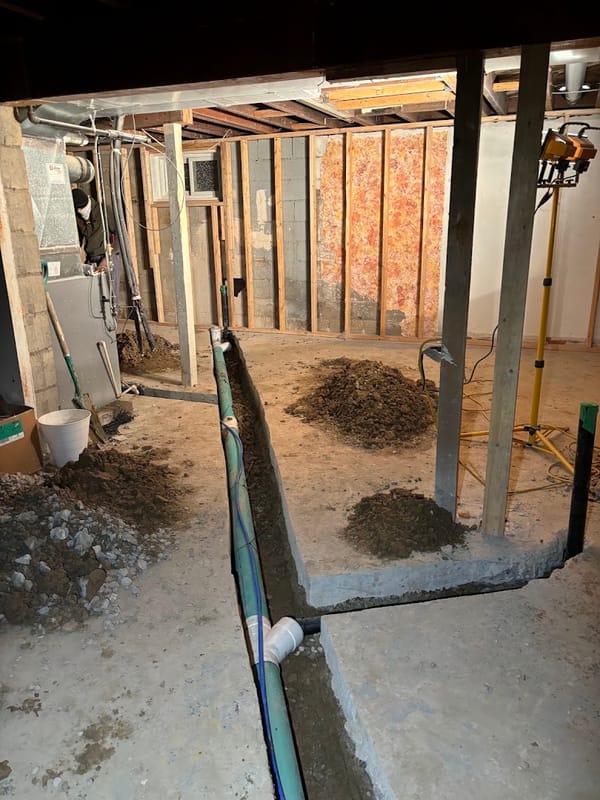 New drain line installed in an excavated basement trench